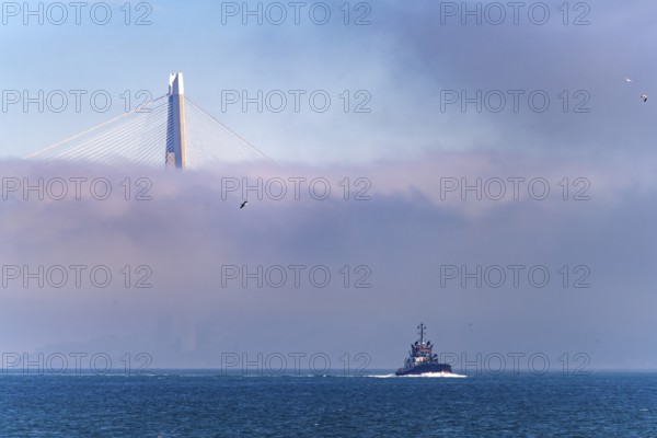 Coast Guard boat on the Bosphorus in front of the Yavuz Sultan Selim Bridge in the fog near