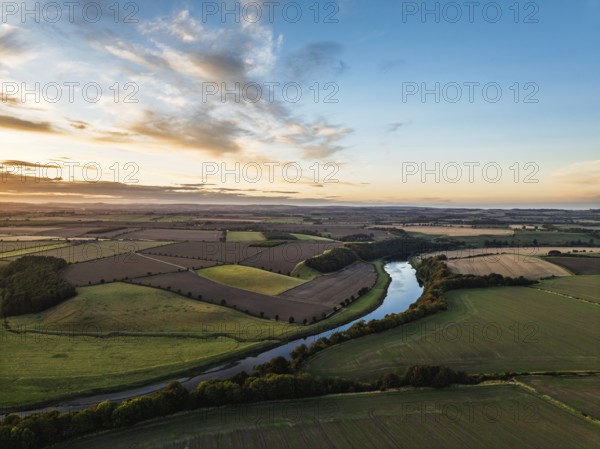 Sunset of Farms and Fields over Norham Castle from a drone, Norham, River Tweed, Northumberland,