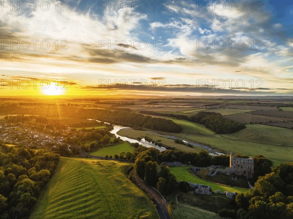 Sunset over Norham Castle and River Tweed from a drone, Norham, Northumberland, England, United