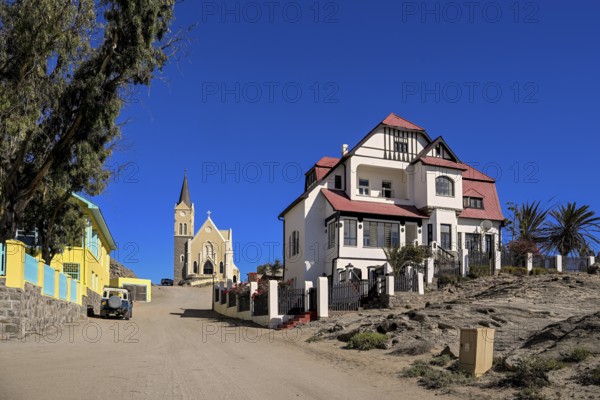 Colonial house facade in the Kirchstraße, in the background the rock church, Lüderitz, Karas