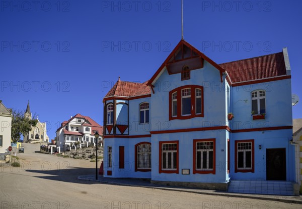 Colonial house facade in the Bergstraße, in the background the rock church, Lüderitz, Karas region,