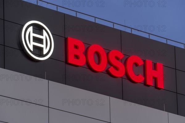 Bosch logo illuminated on the building façade against a blue night sky, Waiblingen,