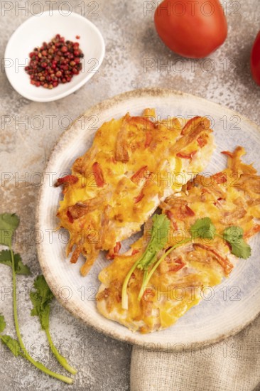 Baked chicken meat with cheese and tomatoes on brown concrete background and linen textile. side