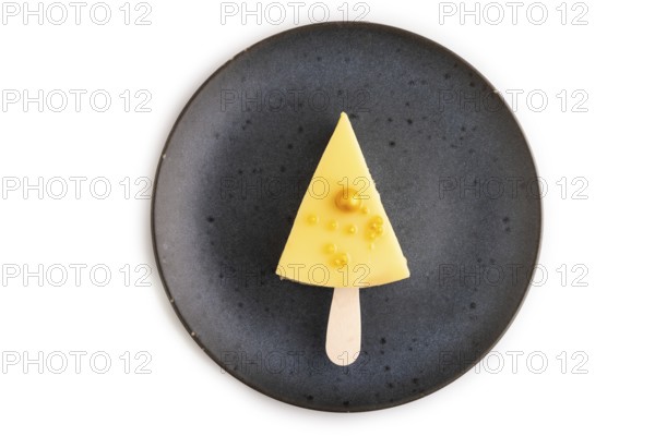 Yellow Cake pop with sprinkles on blue ceramic plate isolated on white background, top view, flat