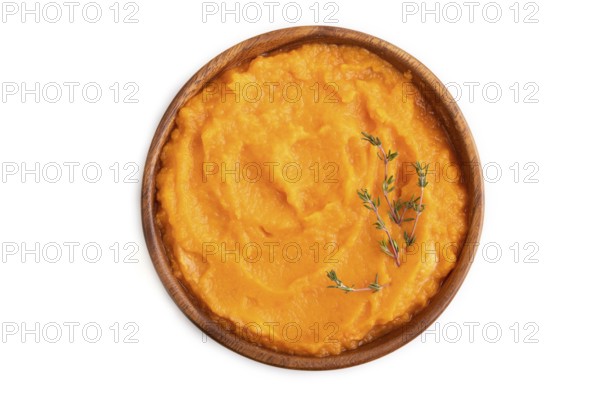 Sweet potato porridge in wooden bowl isolated on white background. Diet, healthy eating concept.