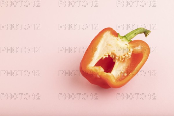 Red Cutted pepper on pink pastel background. Side view, copy space. Tropical, healthy food,