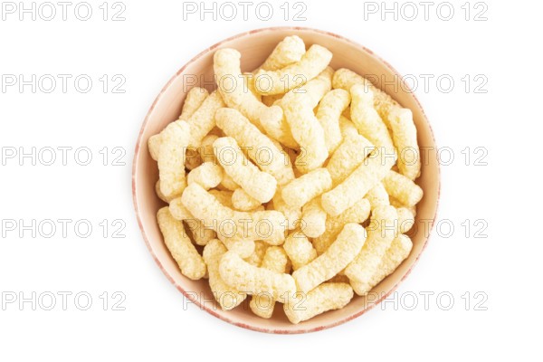Corn flakes sticks with caramel in ceramic bowl isolated on white background. top view, flat lay,