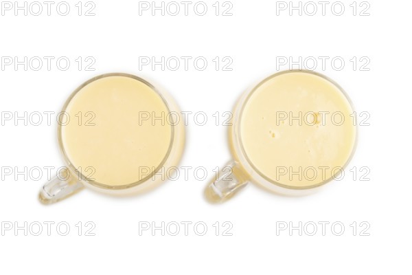 Organic non dairy banana and soy milk in glass isolated on white background. Vegan healthy food