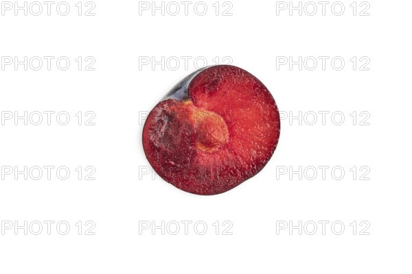 Purple Plum Cut in half isolated on white background. Top view, flat lay, copy space. healthy food,