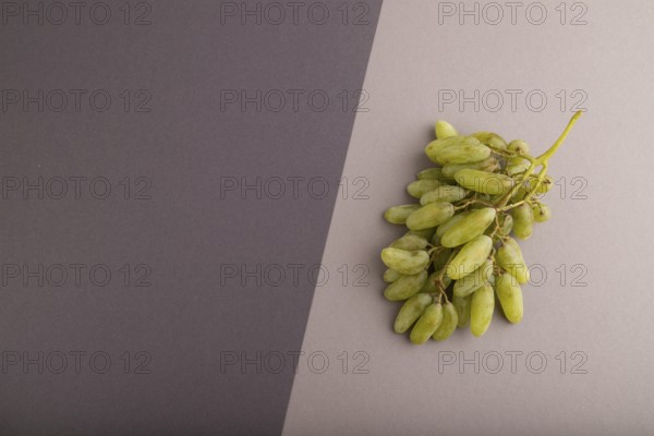 Green grapes on gray and black paper pastel background. Top view, flat lay, copy space. healthy