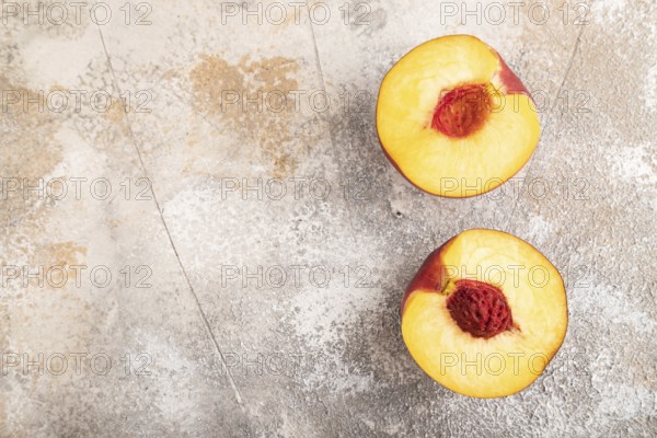 Peach Cut in half on brown concrete background. Top view, flat lay, copy space. healthy food,
