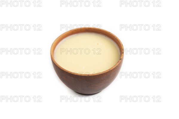 Organic non dairy banana and soy milk in clay cup isolated on white background. Vegan healthy food