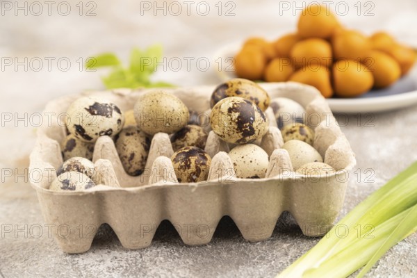Pile of Smoked Quail eggs on plate on a brown concrete background. side view, close up, selective