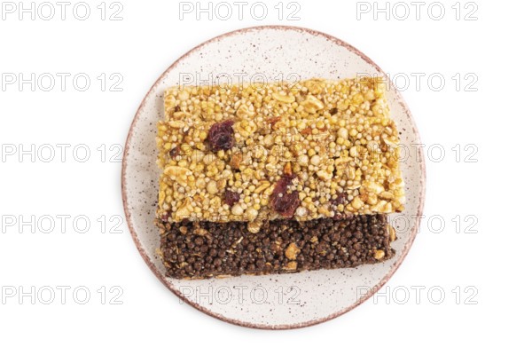 Granola bars with caramel, nuts, flakes in ceramic plate isolated on white background. Top view,