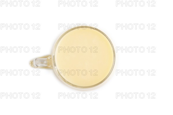 Organic non dairy banana and soy milk in glass isolated on white background. Vegan healthy food