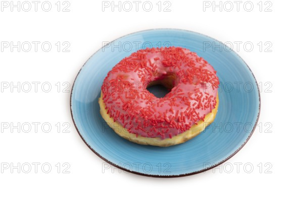 Pink Donut with sprinkles on blue ceramic plate isolated on white background, side view, close up,
