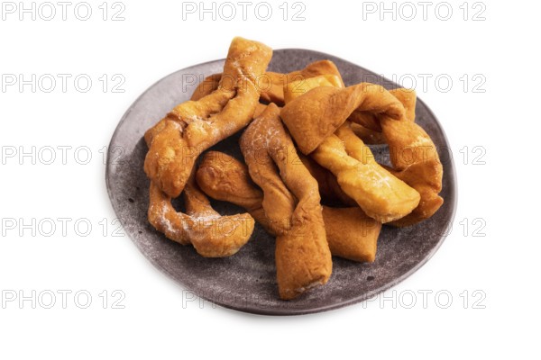 Crunchy biscuit Brushwood cookies sprinkled with powdered sugar isolated on white background, side