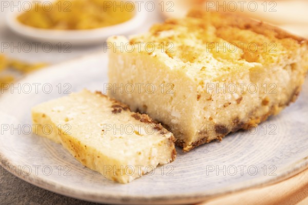 ?ottage cheese ?asserole, Curd cake, with dried apricots and raisins on brown concrete background