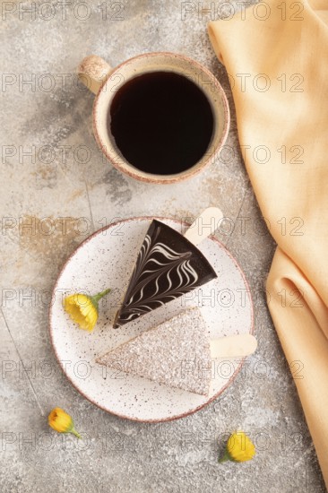 Chocolate and Vanilla Cake pops Marshmallow with cup of coffee on brown concrete background and