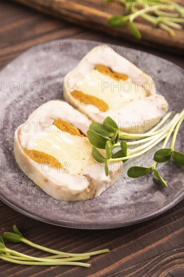 Chicken, egg and dried apricot meatloaf, microgreen on brown wooden. Diet, healthy eating. side