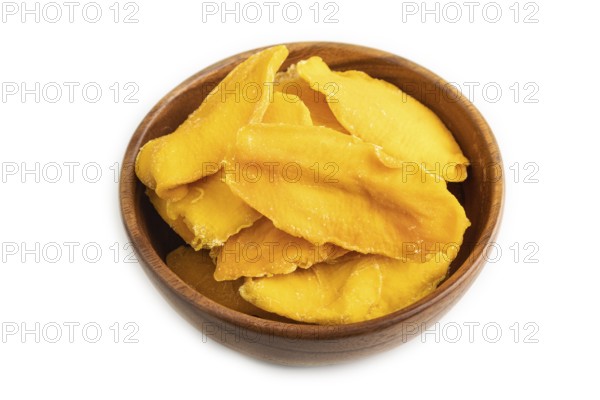Dried Mango in wooden bowl isolated on white background. Side view, close up. healthy food,