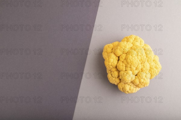 Yellow Cauliflower on black and gray pastel paper background. Top view, flat lay, copy space.