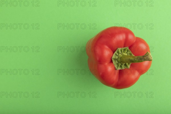 Red pepper on green pastel background. Top view, flat lay, copy space. healthy food, vegetable,