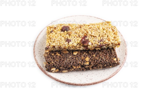 Granola bars with caramel, nuts, flakes in ceramic plate isolated on white background. Side view,