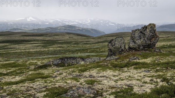 Barren plain landscape with striking rock formation under a cloudy sky, pilgrimage route Olavsweg
