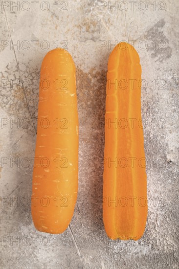 Orange Carrot on brown concrete background. Top view, close up, flat lay. healthy food, vegetable,