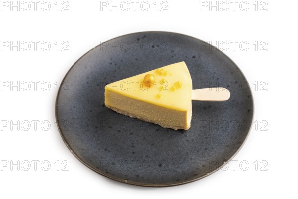 Yellow Cake pop with sprinkles on blue ceramic plate isolated on white background, side view, close