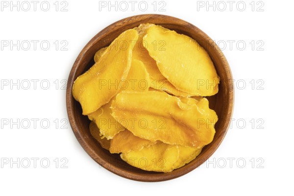 Dried Mango in wooden bowl isolated on white background. Top view, close up, flat lay. healthy
