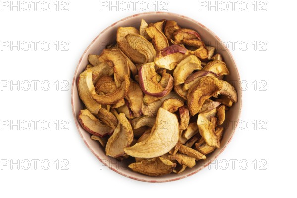 Dried Apples in ceramic bowl isolated on white background. Top view, close up, flat lay. healthy