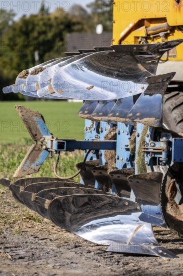 Plough, for ploughing a field, field, ploughshares, agricultural technology, shiny stainless steel,