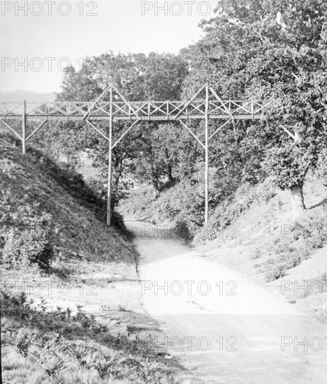 Magic lantern slide of footbridge crossing the road at Wilford Hollows, Bromeswell, Suffolk,