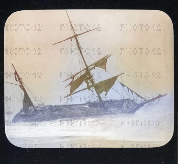 Shipwreck of wooden sailing ship on beach in stormy sea, location unspecified, c 1900 colourised
