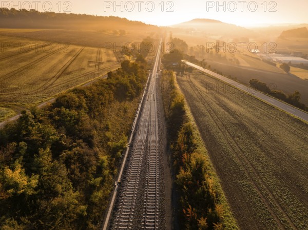 Railway tracks cutting through a rural landscape at sunrise, Hermann Hesse railway, Ostelsheim,