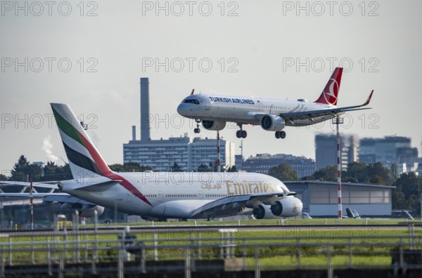 Turkish Airlines Airbus A321neo lands at Düsseldorf Airport, Emirates Airbus A380 taxis for