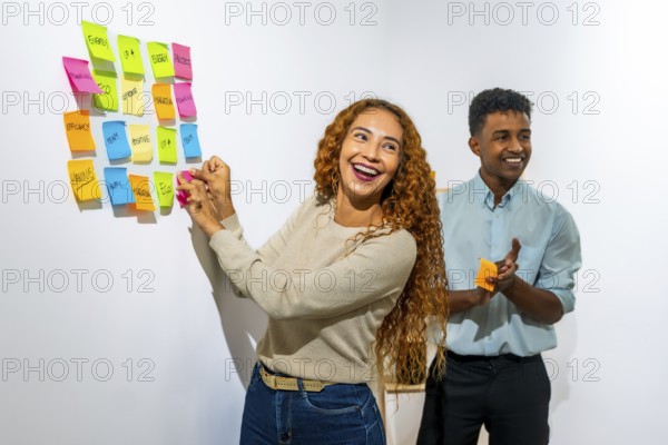 Diverse business colleagues working together, collaborating on a project, enthusiastically posting