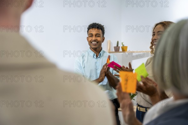 Diverse business people actively participating in a creative brainstorming session, discussing new