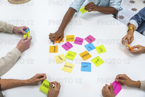 Diverse business professionals collaborating on a project, sharing ideas, and developing strategies