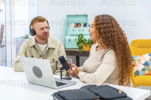 Diverse man and woman hosting a podcast, looking at each other while discussing topics and