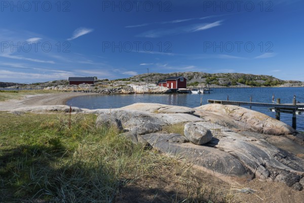 Falun red or Swedish red boathouse in a small bay, Resö island, Bohuslän, Skagerrak, Sotenäs,
