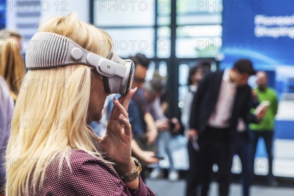 Mercedes exhibition stand. The Virtual Ride. Trade fair visitor with 3D glasses. IAA MOBILITY in