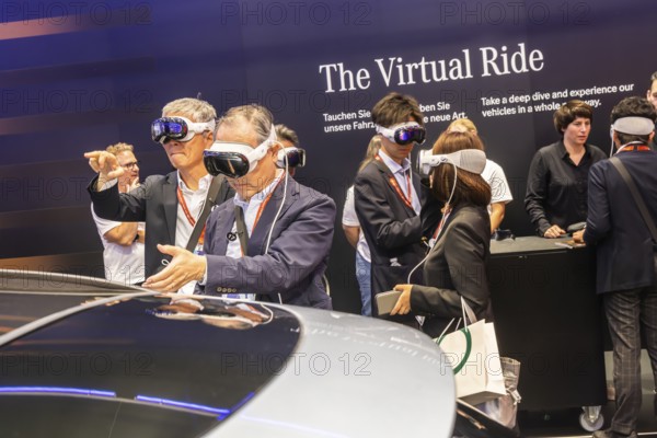 Mercedes trade fair stand with virtual presentation. Trade fair visitors with 3D glasses. The