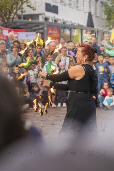 A dancer holds torches in her hand and fascinates the audience with her performance, Feuernacht,