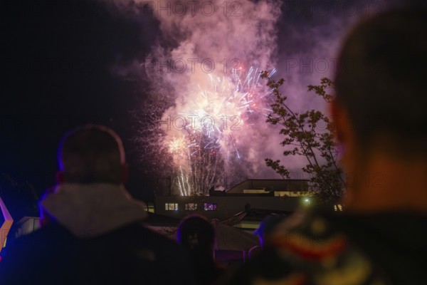 A spectacular firework display unfolds in the night sky while spectators watch, Fire Night,