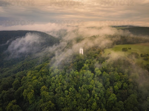 Fog envelops tower and forests, morning mood creates a peaceful atmosphere, Schönberg Tower,