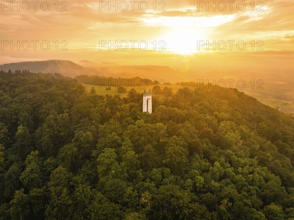 A white tower stands in a forest at sunset in the soft light, Schönbergturm, Pfullingen, Swabian