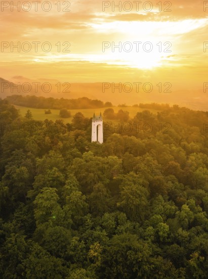 Tower in the middle of a forest under an orange-coloured sky at sunset, Schönberg Tower,